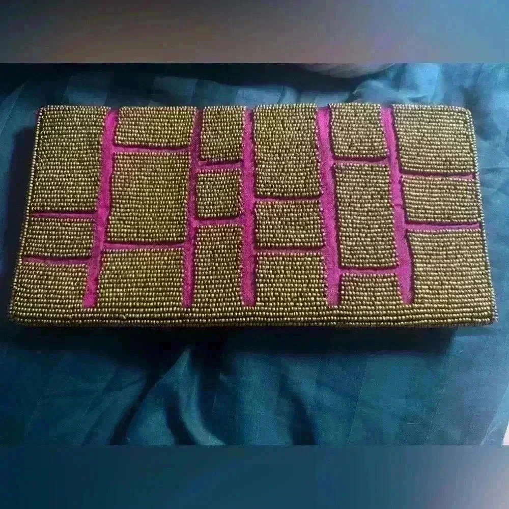 ExpressionsNYC clutch. Pick with gold beads. Good condition pink sink inside